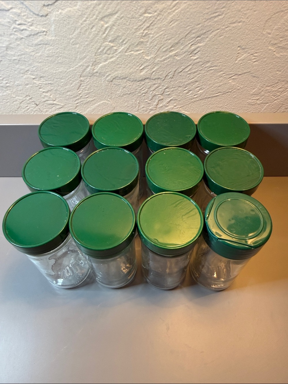 Set of 12 Vintage Glass Round Spice Jars W/ Green Lids, Approximately 4.5” Tall - Picture 2 of 8